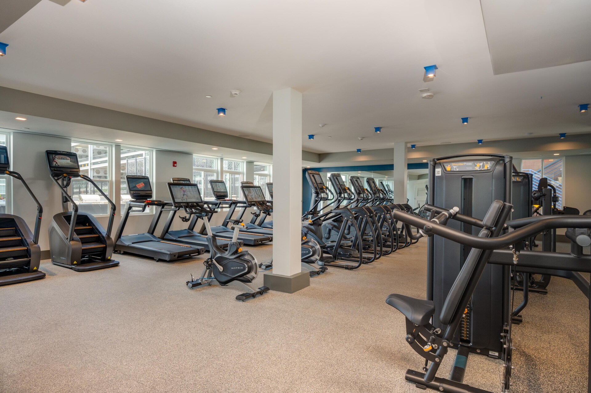 Fitness room with cardio equipment.